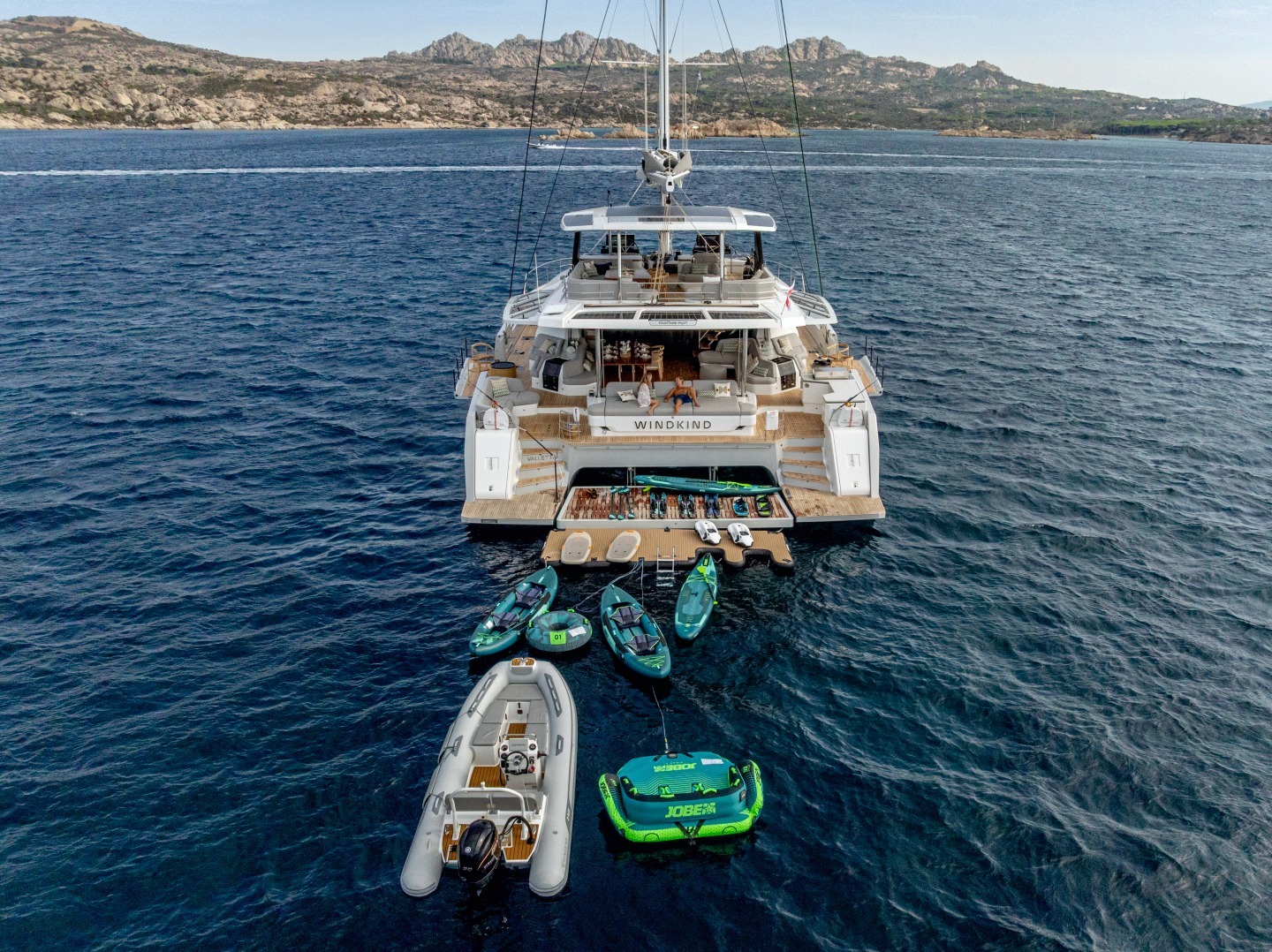 WINDKIND at anchor with the beach club open and all water toys astern
