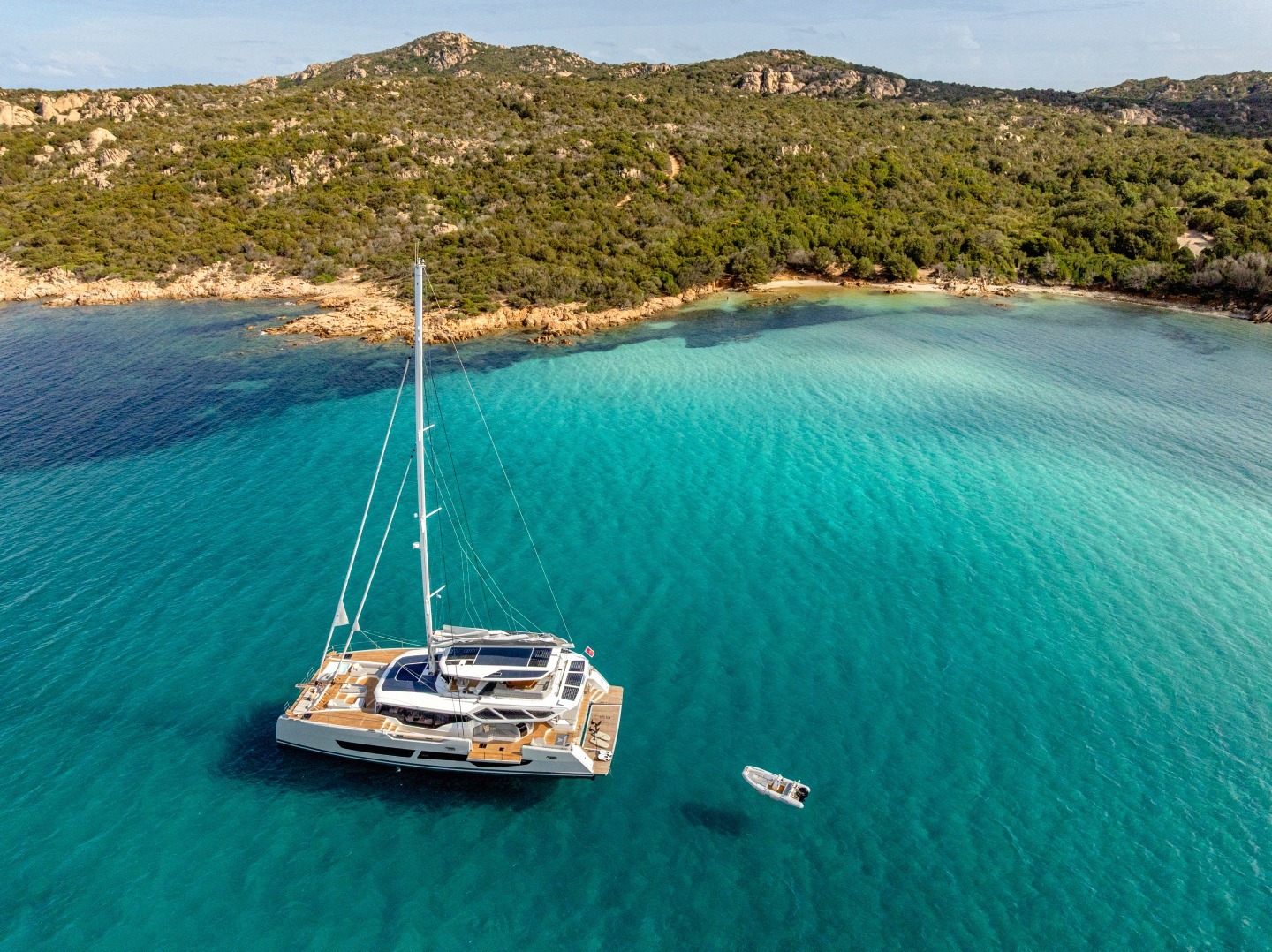WINDKIND at anchor in turquoise water off Sardinia