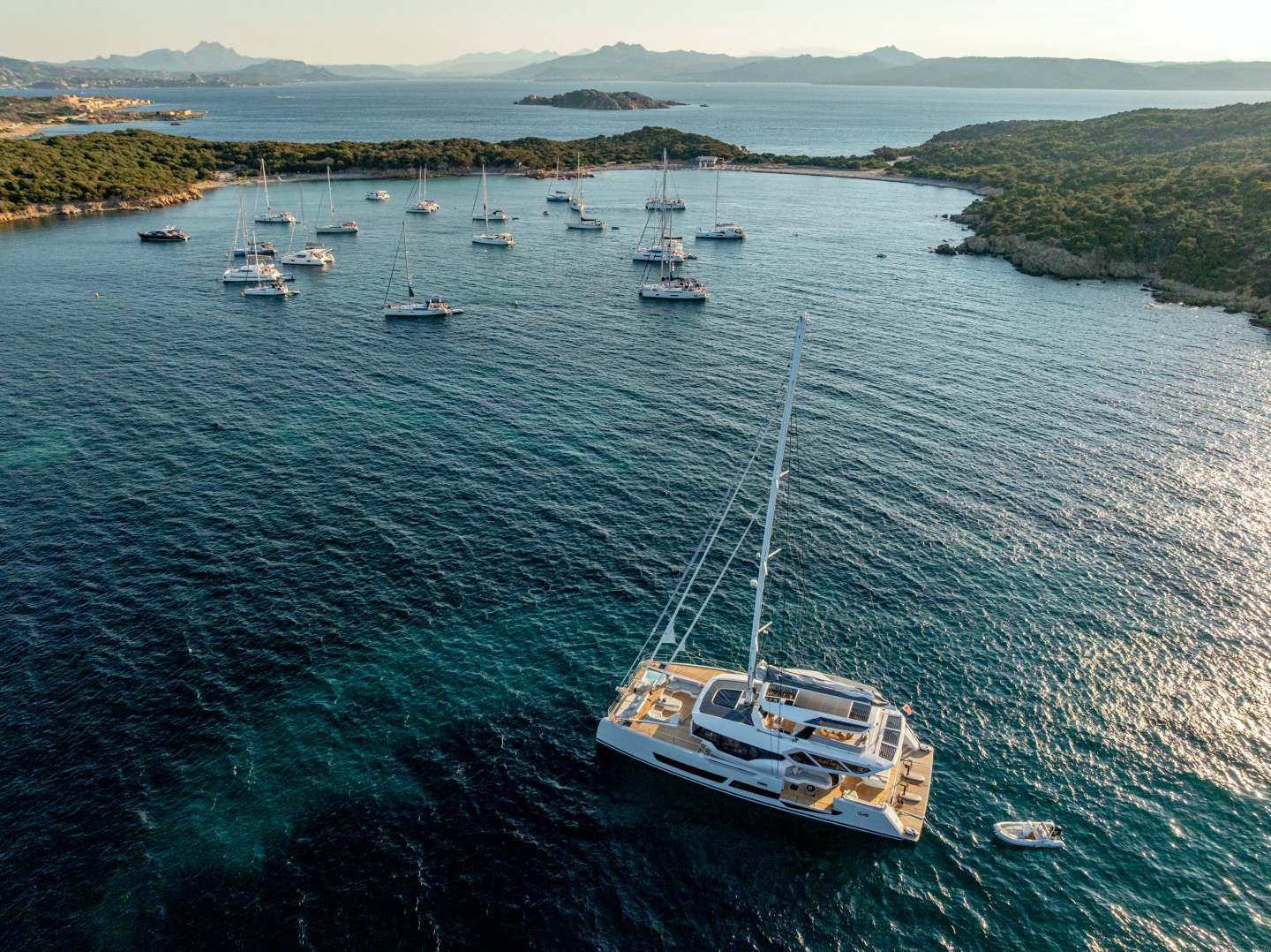 WINDKIND at anchor in a bay off Sardinia in the evening light