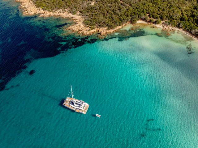 WINDKIND at anchor in a turquoise bay off Sardinia